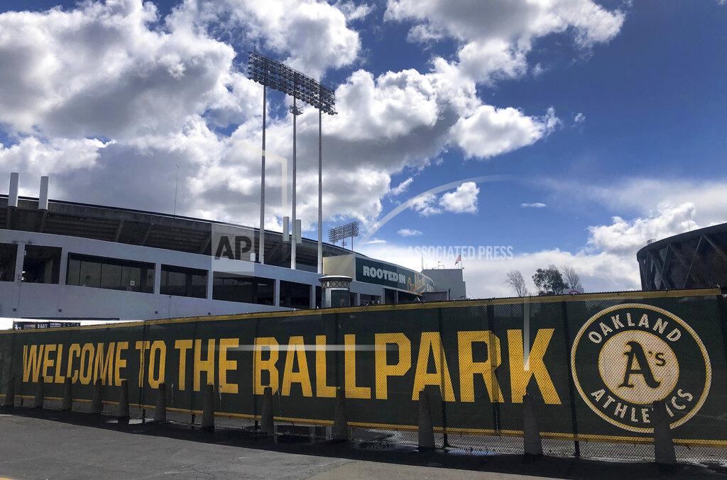 Ben Margot FILE — In this March 25, 2020, file photo a banner has a welcome message to Oakland Athletics fans at the Oakland-Alameda County Coliseum in Oakland, Calif. The Oakland City Council approved Tuesday, July 20, 2021, preliminary terms for a new $12 billion waterfront ballpark project for the Athletics. But it's not clear if the 6-1 vote will be enough to keep the A's at the negotiating table instead of leaving the city. (AP Photo/Ben Margot,File)