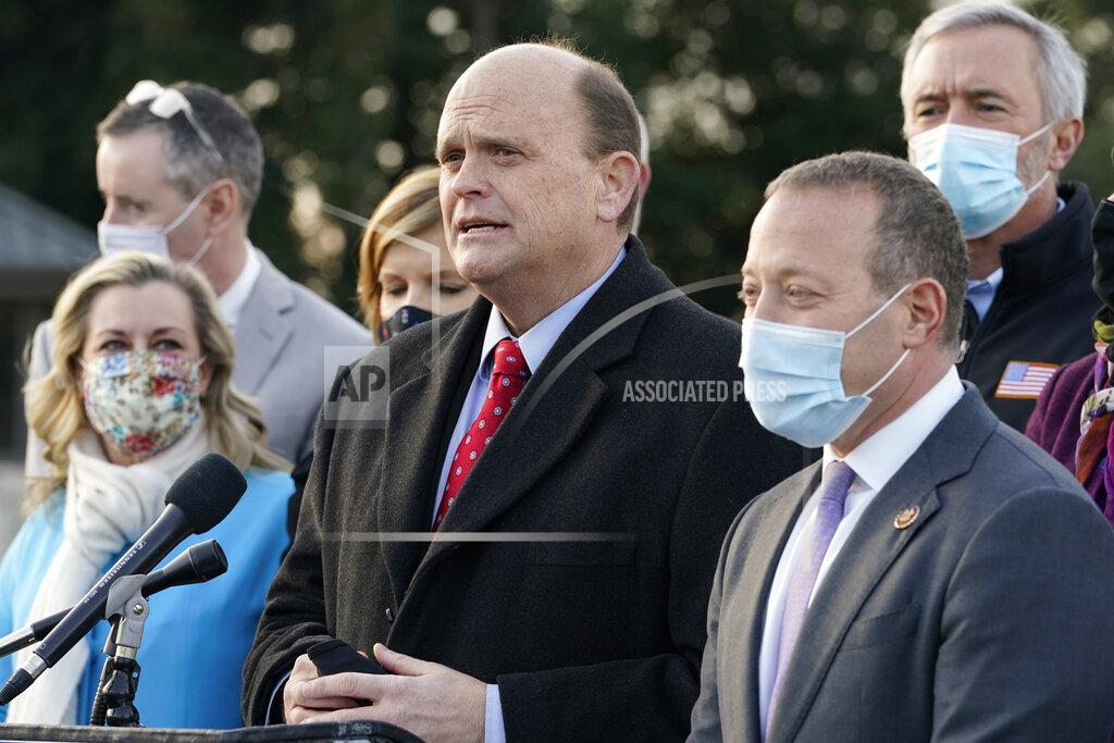 Jacquelyn Martin Problem Solvers Caucus co-chairs Rep. Tom Reed, R-N.Y., center, and Rep. Josh Gottheimer, D-N.J., right, speak to the media with members of their caucus about the expected passage of the emergency COVID-19 relief bill, Monday, Dec. 21, 2020, on Capitol Hill in Washington. Congressional leaders have hashed out a massive, year-end catchall bill that combines $900 billion in COVID-19 aid with a $1.4 trillion spending bill and reams of other unfinished legislation on taxes, energy, education and health care. (AP Photo/Jacquelyn Martin)