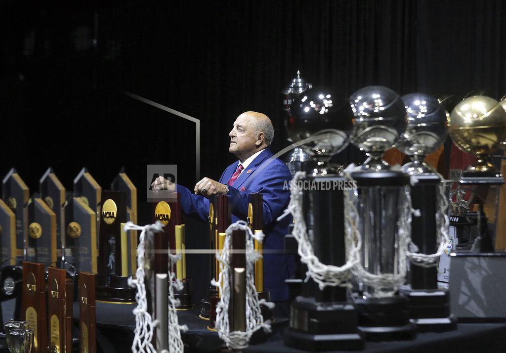 John Hart University of Wisconsin Athletic Director Barry Alvarez is pictured among some of the championship trophies won by the university's sports teams during his tenure as a coach and athletic director at an event marking his retirement announcement at the Kohl Center in Madison, Wis. Tuesday, April 6, 2021. (John Hart/Wisconsin State Journal via AP)
