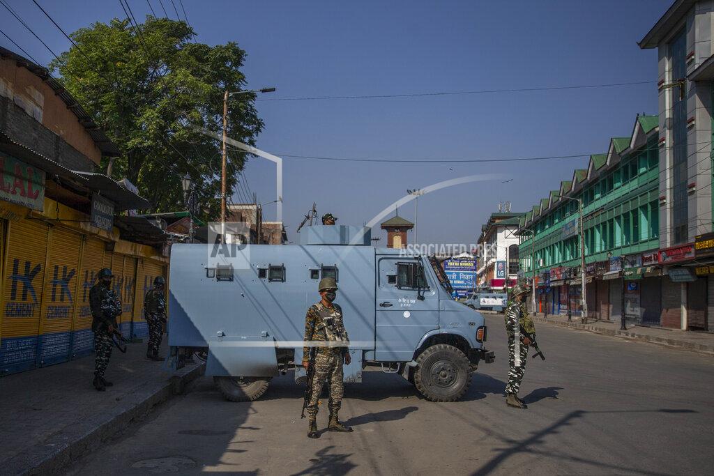 Dar Yasin Paramilitary soldiers stand guard on a deserted street on the first anniversary of India’s decision to revoke the disputed region’s semi-autonomy, in Srinagar, Indian controlled Kashmir, Wednesday, Aug. 5, 2020. Last year on Aug. 5, India’s Hindu-nationalist-led government of Prime Minister Narendra Modi stripped Jammu-Kashmir of its statehood and divided it into two federally governed territories. Late Tuesday, authorities lifted a curfew in Srinagar but said restrictions on public movement, transport and commercial activities would continue because of the coronavirus pandemic. (AP Photo/ Dar Yasin)