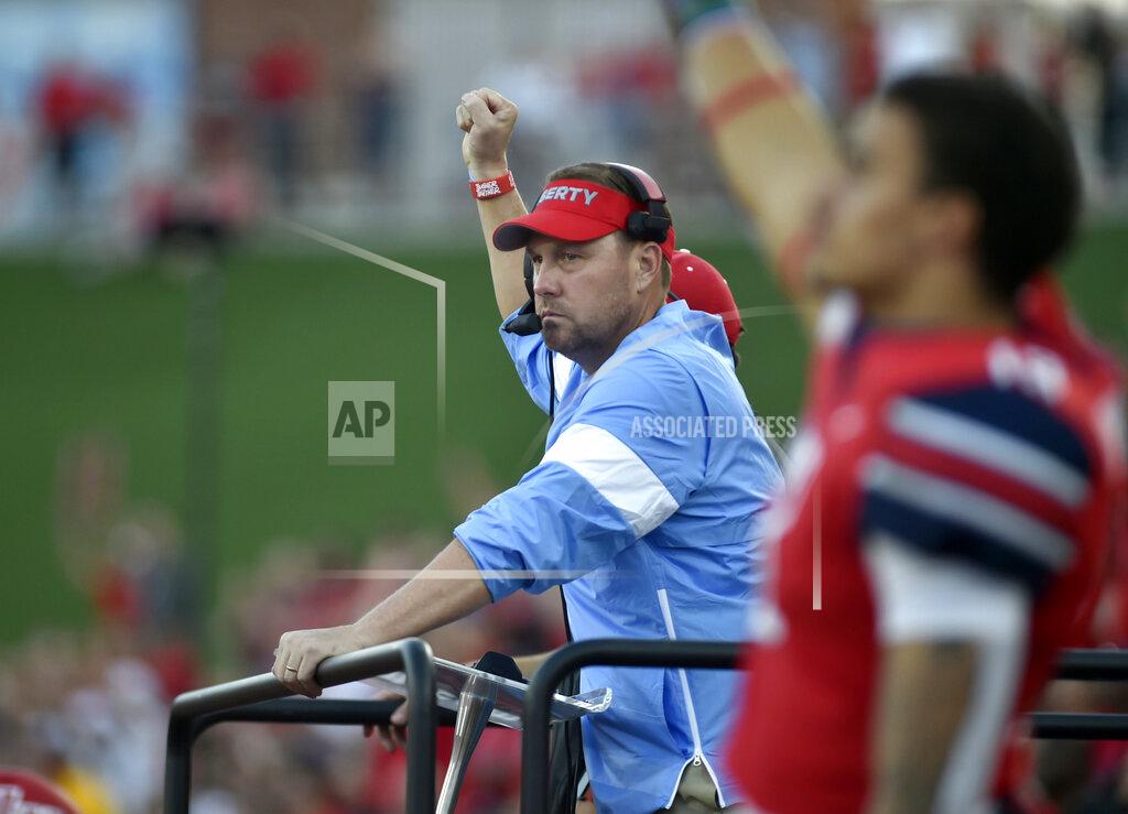 Taylor Irby Liberty coach Hugh Freeze celebrates after a touchdown against Hampton during a college football game in Lynchburg, Va., Saturday, Sept. 21, 2019. (Taylor Irby/The News & Advance via AP)