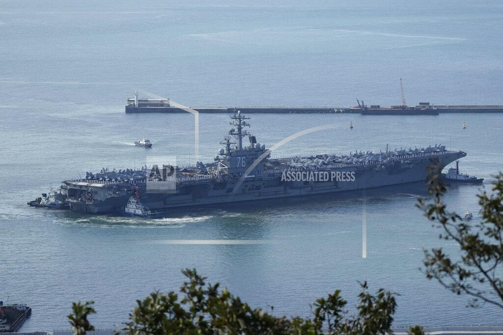 Lee Jin-Man U.S. aircraft carrier USS Ronald Reagan is escorted into port in Busan, South Korea, Friday, Sept. 23, 2022. The USS Ronald Reagan arrived to participate in upcoming joint military drills with South Korea in the East Sea – the first time since 2017. (AP Photo/Lee Jin-man)