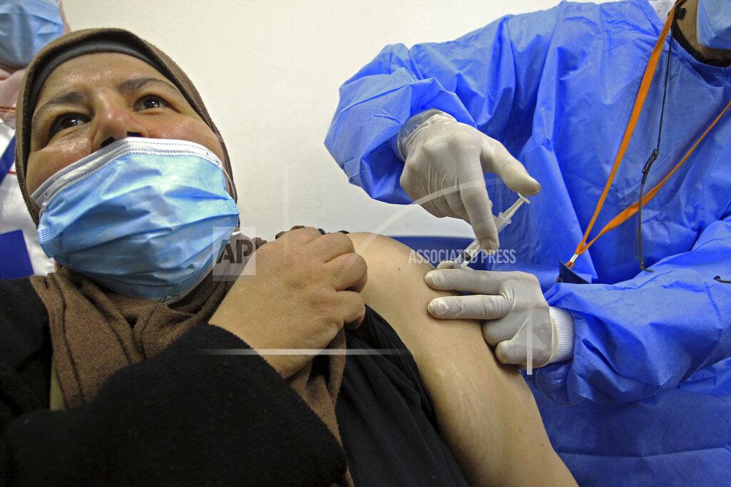 Fateh Guidoum A woman receives the Sputnik-V COVID-19 vaccine at a vaccination center in Blida, south of Algiers, Algeria, Saturday, Jan. 30, 2021. The vaccines were delivered to the Boufarik military airport west of Algiers, Minister Amar Belhimeur said in a statement. He did not indicate how many arrived, though the government had said it had ordered a first batch of 500,000 Sputnik doses. (AP Photo/Fateh Guidoum)