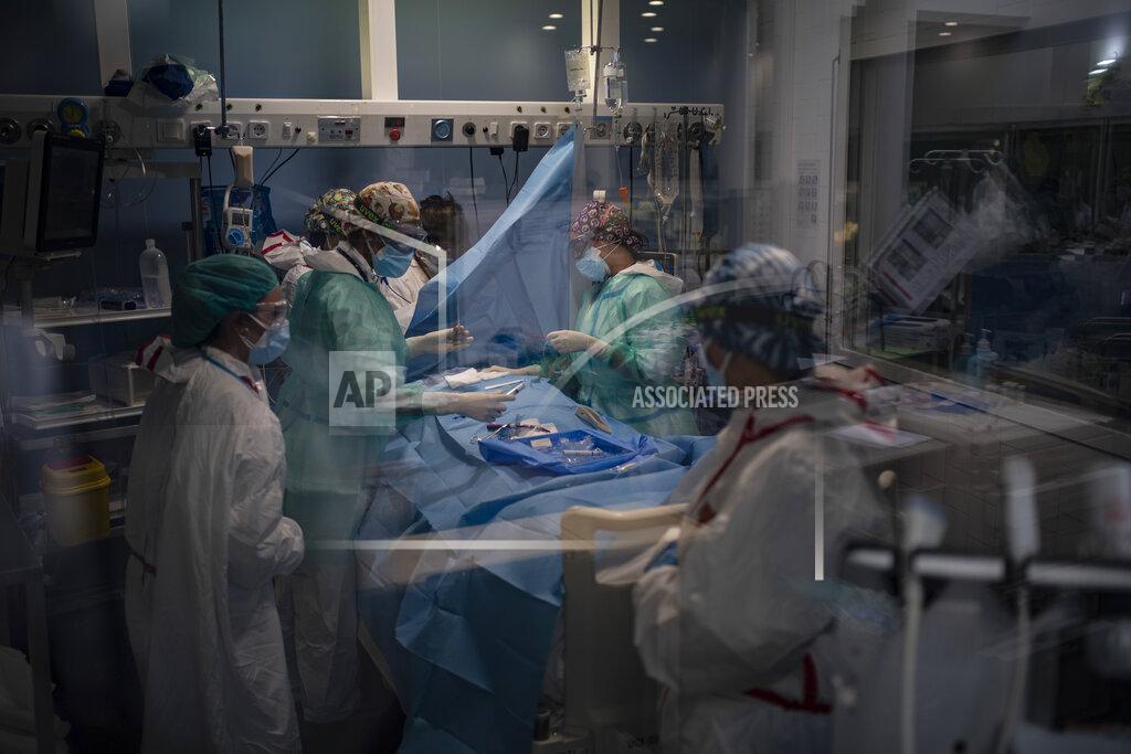 Felipe Dana A COVID-19 patient receives treatment in the ICU of the Hospital del Mar, in Barcelona, Spain, Tuesday, Jan. 19, 2021. The unrelenting increase in COVID-19 infections in Spain following the holiday season is again straining hospitals, threatening the mental health of doctors and nurses who have been at the forefront of the pandemic for nearly a year. (AP Photo/Felipe Dana)