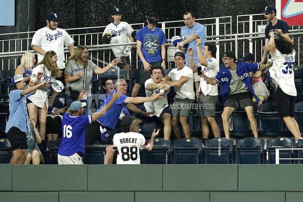 Charlie Riedel Fans try to catch ball hit by Kansas City Royals' MJ Melendez for a two-run home run during the eighth inning of a baseball game against the Chicago White Sox Wednesday, May 18, 2022, in Kansas City, Mo. (AP Photo/Charlie Riedel)