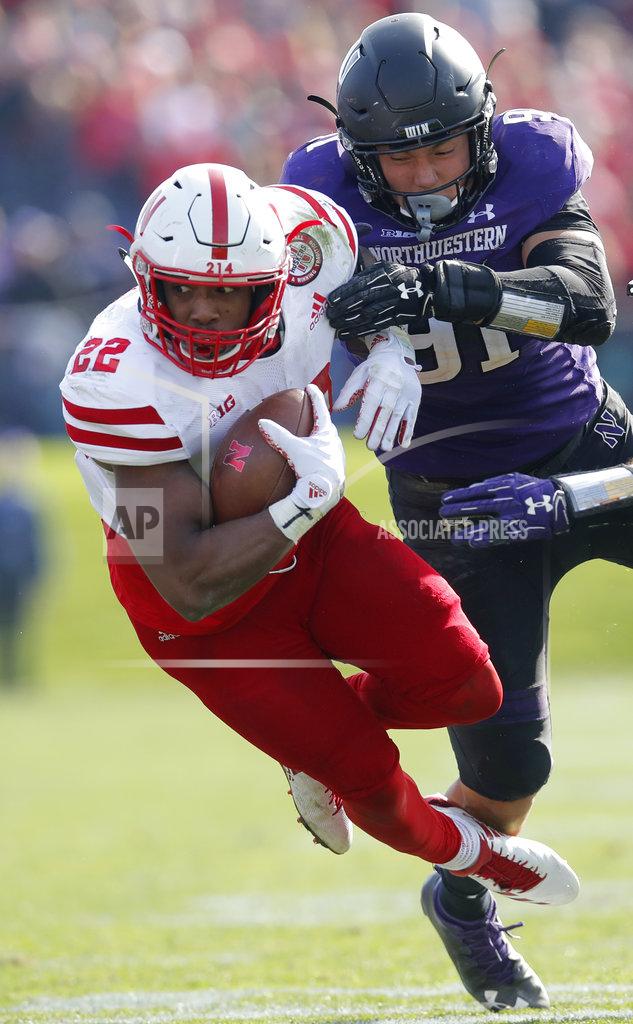 Jim Young Nebraska's Devine Ozigbo, left, is tackled by Northwestern's Samdup Miller during the second half of an NCAA college football game Saturday, Oct. 13, 2018, in Evanston, Ill. (AP Photo/Jim Young)