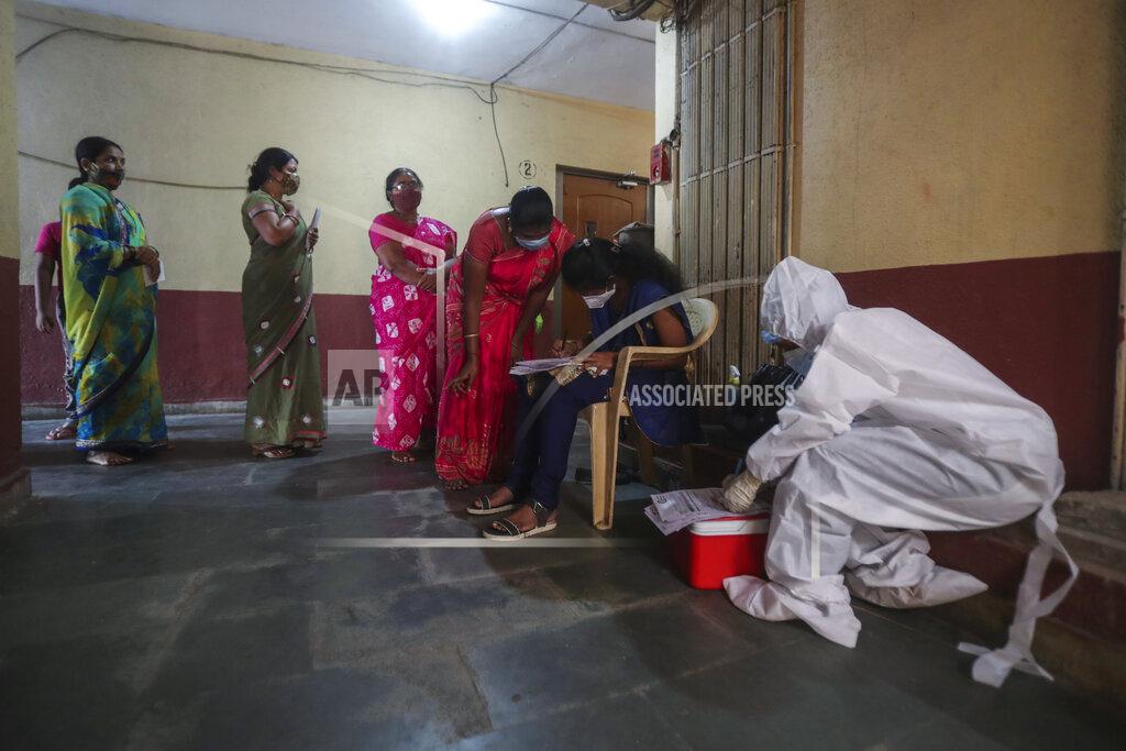 Rafiq Maqbool People register themselves to get tested during a door-to-door screening for COVID-19 people at Dharavi, one of Asia's largest slums, in Mumbai, India, Wednesday, March 17, 2021. (AP Photo/Rafiq Maqbool)
