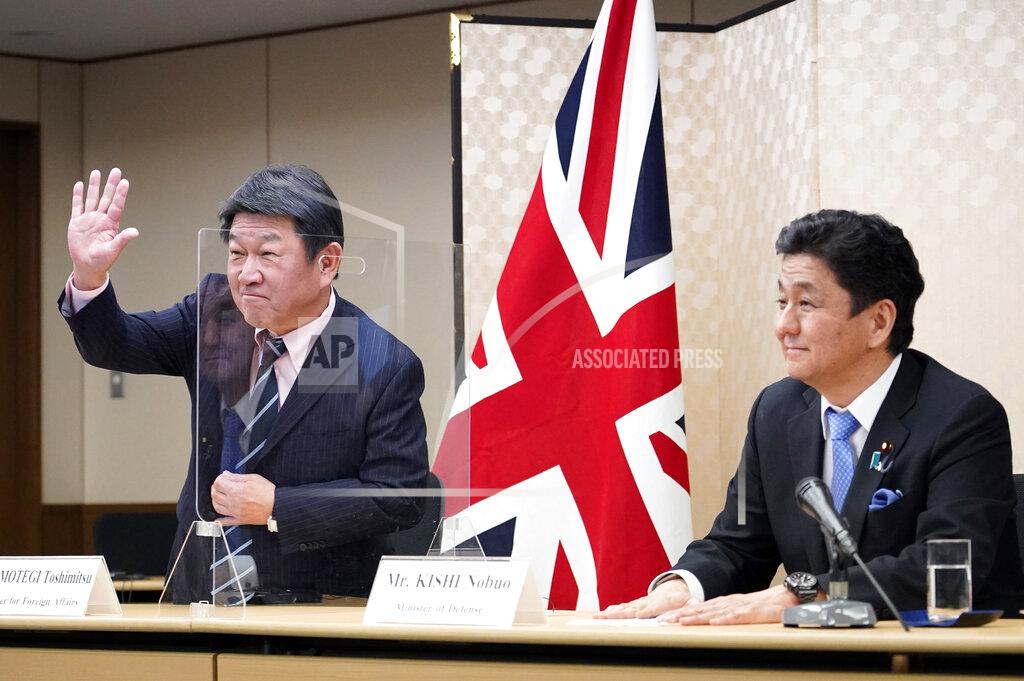 Franck Robichon Japan's Foreign Minister Toshimitsu Motegi, left, and Defense Minister Nobuo Kishi attend a video conference with British Foreign Secretary Dominic Raab and Defense Minister Ben Wallace on screen, not seen, at the Foreign Ministry in Tokyo, Feb. 3 2021. Both parties held their 4th Japan-UK Foreign and Defense Ministerial Meeting '2+2' to strengthen their cooperation. (Franck Robichon/Pool via AP)