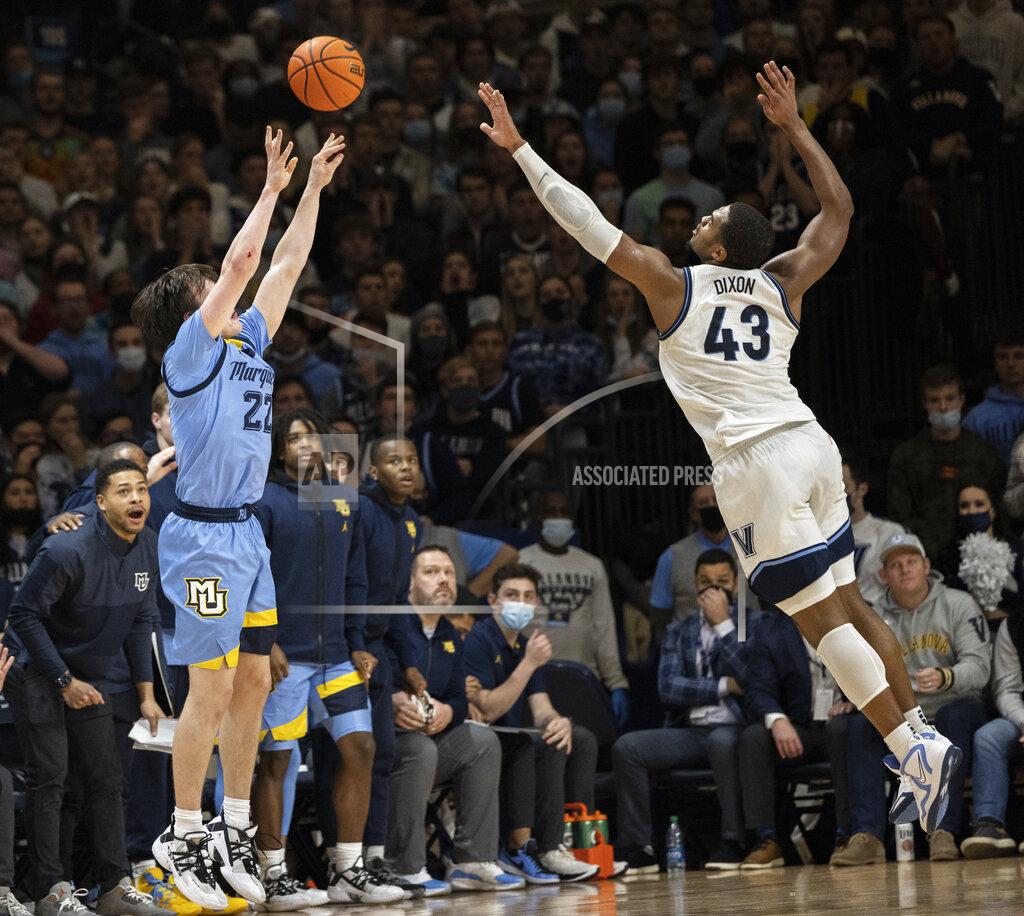 Laurence Kesterson Marquette guard Tyler Kolek (22) takes a three point shot over Villanova forward Eric Dixon (43) during the second half of an NCAA college basketball game, Wednesday, Jan. 19, 2022, in Villanova, Pa. (AP Photo/Laurence Kesterson)