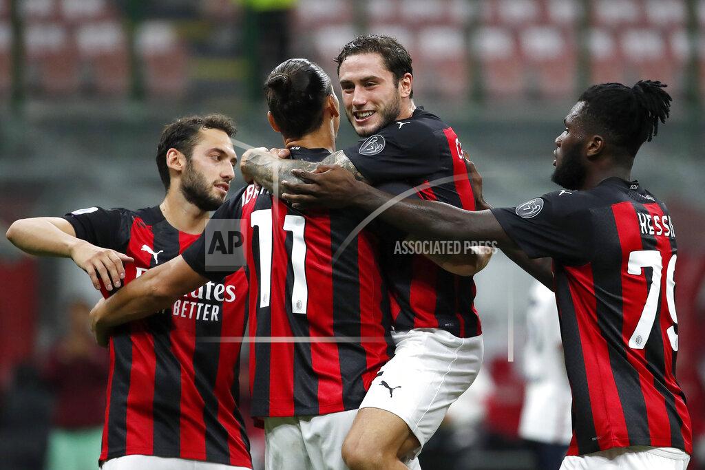 Antonio Calanni AC Milan's Zlatan Ibrahimovic, second from left, celebrates with his teammates his second goal on a penalty against Bologna during the Serie A soccer match between AC Milan and Bologna at the San Siro stadium, in Milan, Italy, Monday, Sept. 21, 2020. (AP Photo/Antonio Calanni)