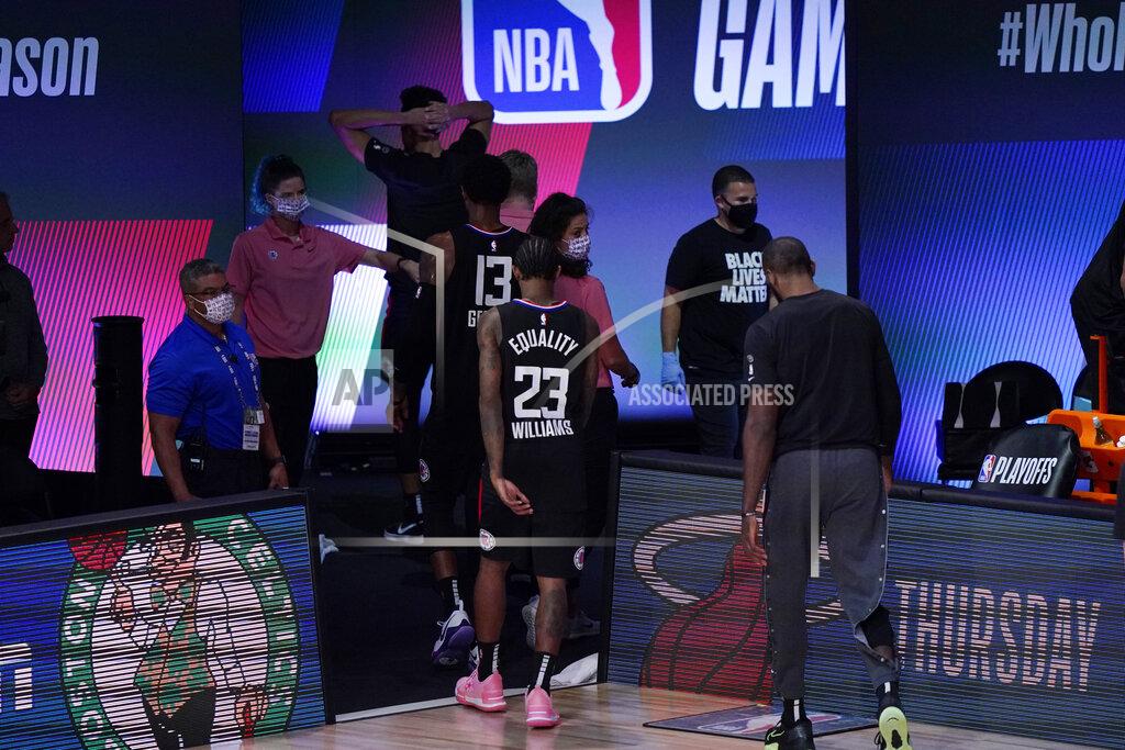 Mark J. Terrill Los Angeles Clippers players walk off of the court following their loss to the Denver Nuggets in an NBA conference semifinal playoff basketball game Tuesday, Sept. 15, 2020, in Lake Buena Vista, Fla. (AP Photo/Mark J. Terrill)
