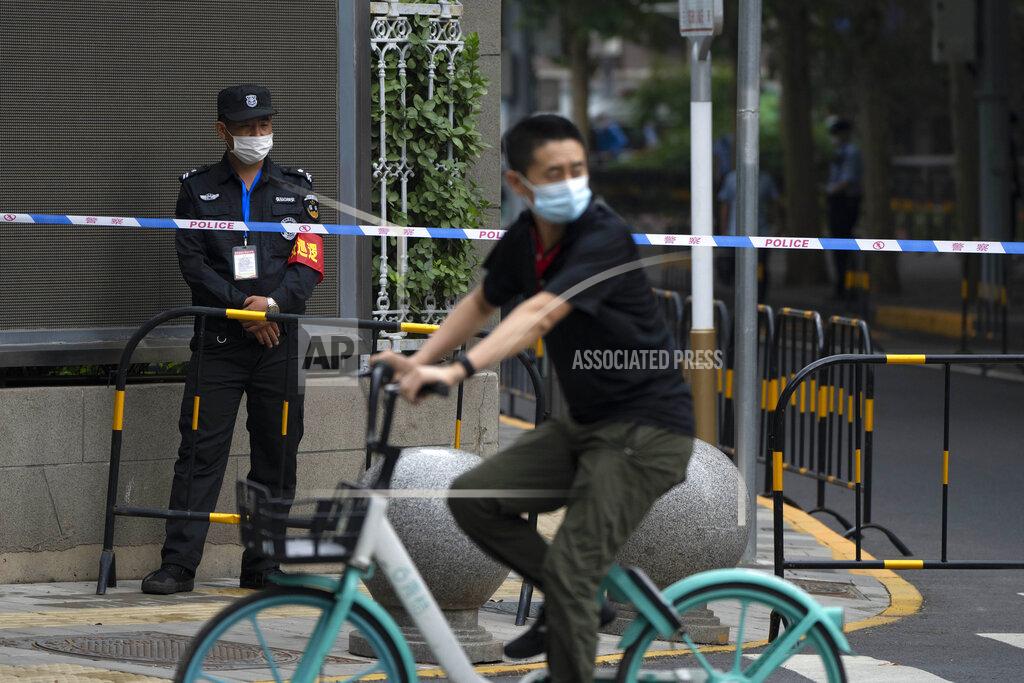 Mark Schiefelbein A security office stands guard at a barricade outside a courthouse in Beijing, Tuesday, Sept. 14, 2021. A young Chinese woman headed to court Tuesday amid a police cordon and antagonistic bystanders in one of the few remaining MeToo cases from a tamped-down movement whose legacy remains uncertain. (AP Photo/Mark Schiefelbein)