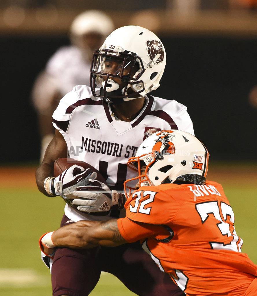 Brody Schmidt Missouri State's Matt Rush is wrapped up by Oklahoma State's Malik Givens during the second half of an NCAA college football game in Stillwater, Okla., Thursday, Aug. 30, 2018. (AP Photo/Brody Schmidt)