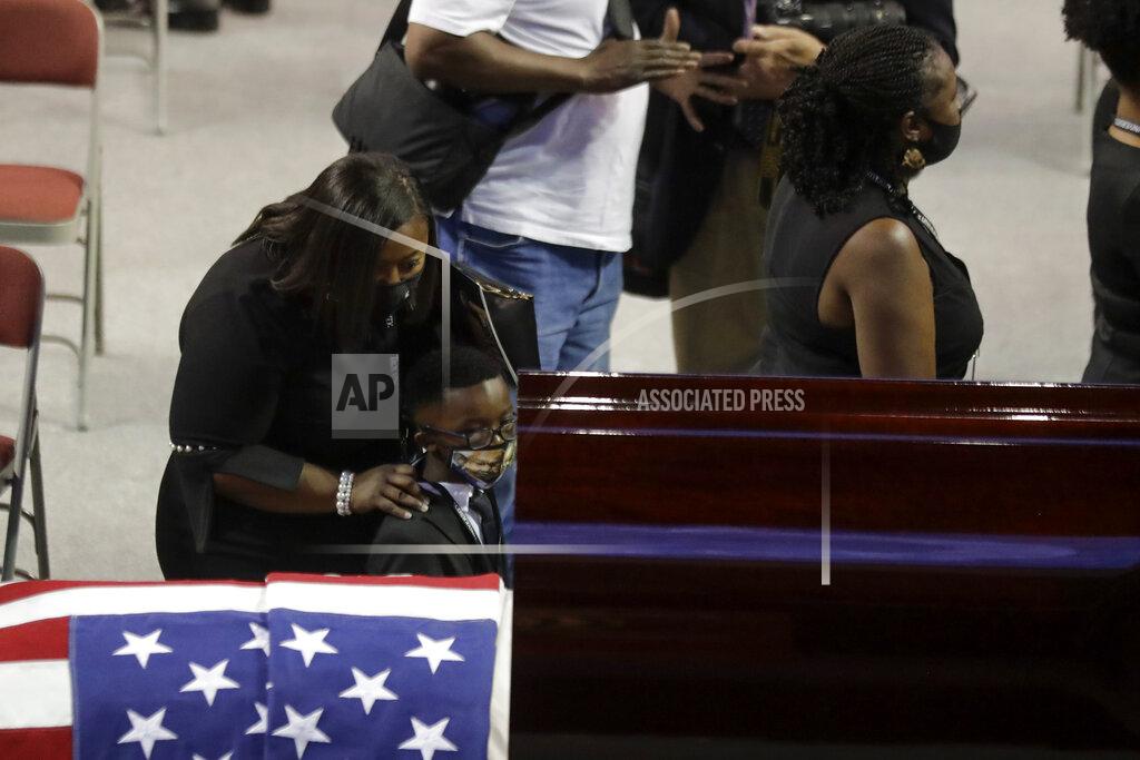Brynn Anderson Mourners walk past the casket during the service for the late Rep. John Lewis, D-Ga., at Troy University on Saturday, July 25, 2020, in Troy, Ala. Lewis, who carried the struggle against racial discrimination from Southern battlegrounds of the 1960s to the halls of Congress, died Friday, July 17, 2020. (AP Photo/Brynn Anderson)