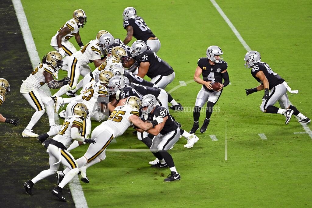 David Becker Las Vegas Raiders quarterback Derek Carr (4) prepares to hand off the ball against the New Orleans Saints during the second half of an NFL football game, Monday, Sept. 21, 2020, in Las Vegas. (AP Photo/David Becker)
