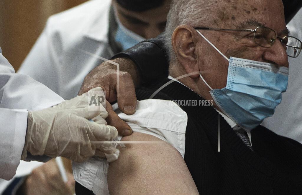 Khalil Hamra Former Palestinian Health Minister Riyad al-Zanoun receives a shot of the Russian-made Sputnik V coronavirus vaccine, in Gaza City, Monday, Feb. 22, 2021. (AP Photo/Khalil Hamra)