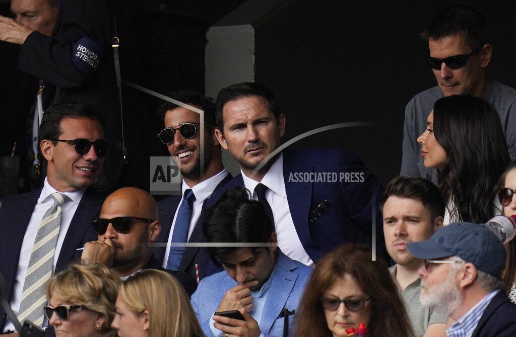 Kirsty Wigglesworth Former soccer player Frank Lampard, centre, his wife Christine Lampard, right, Formula One driver Daniel Ricciardo, second left, watch the men's singles semifinals match on day eleven of the Wimbledon Tennis Championships in London, Friday, July 9, 2021. (AP Photo/Kirsty Wigglesworth)