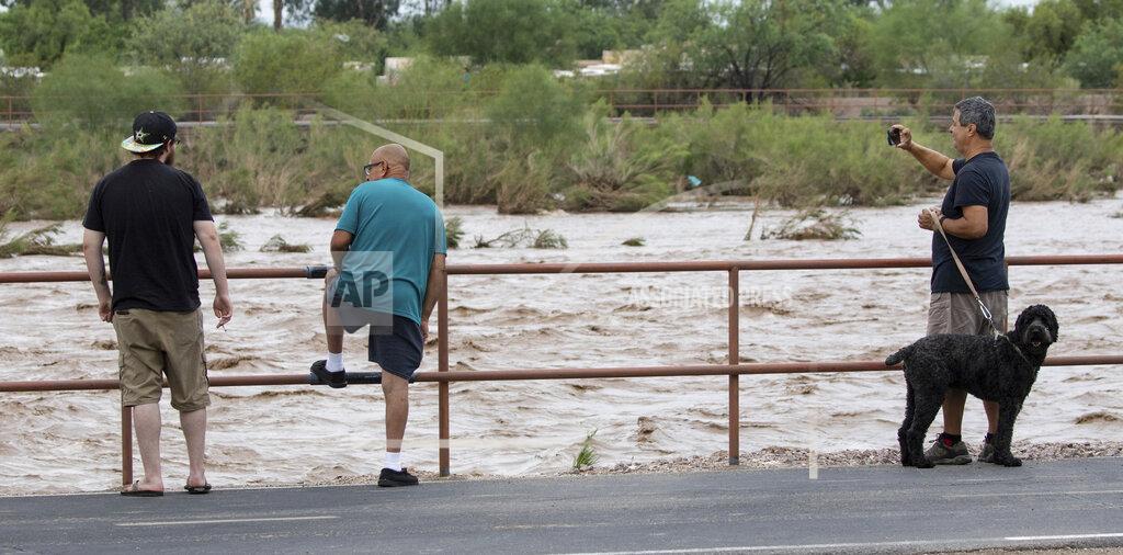 Rick Wiley The Rillito River rolling along just west of Swan Road after a powerful storm with heavy rain landed over the Tucson area, Ariz., early Friday, July 23, 2021. (Rick Wiley/Arizona Daily Star via AP)