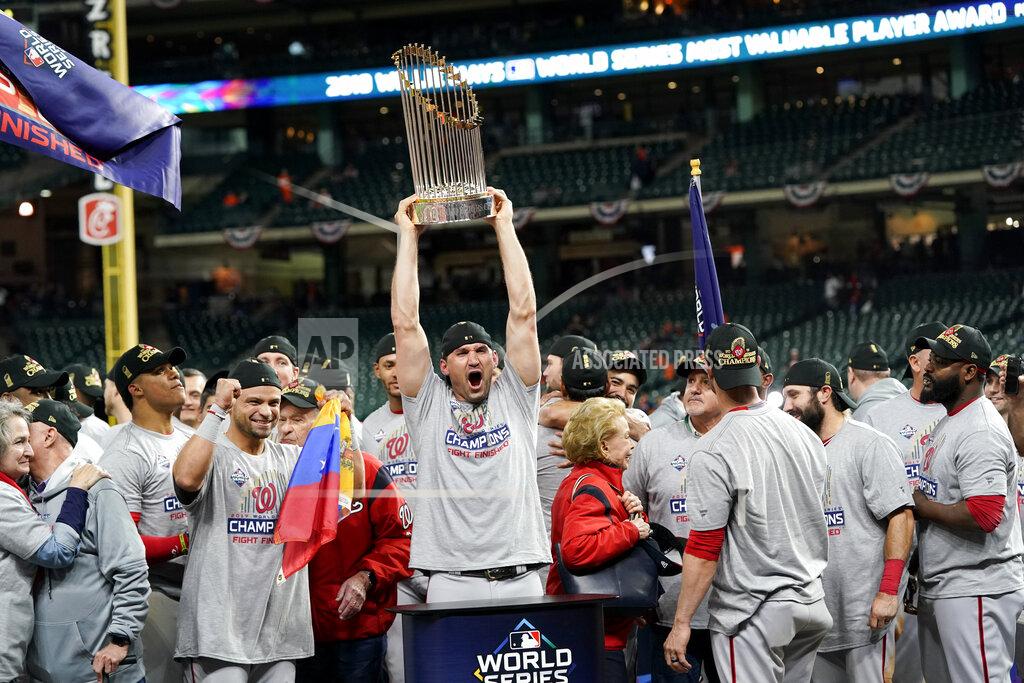 David J. Phillip FILE - In this Oct. 30, 2019, file photo, Washington Nationals first baseman Ryan Zimmerman celebrates with the trophy after Game 7 of the baseball World Series against the Houston Astros in Houston. In the third installment of Washington Nationals star Ryan Zimmerman's diary for the AP, he discusses a fundraising initiative that has drawn support from teammates and athletes from other sports in the D.C. area to help hospital workers dealing with the coronavirus pandemic. Zimmerman also discusses what it was like to re-watch Game 7 of the World Series this week. (AP Photo/David J. Phillip, File)