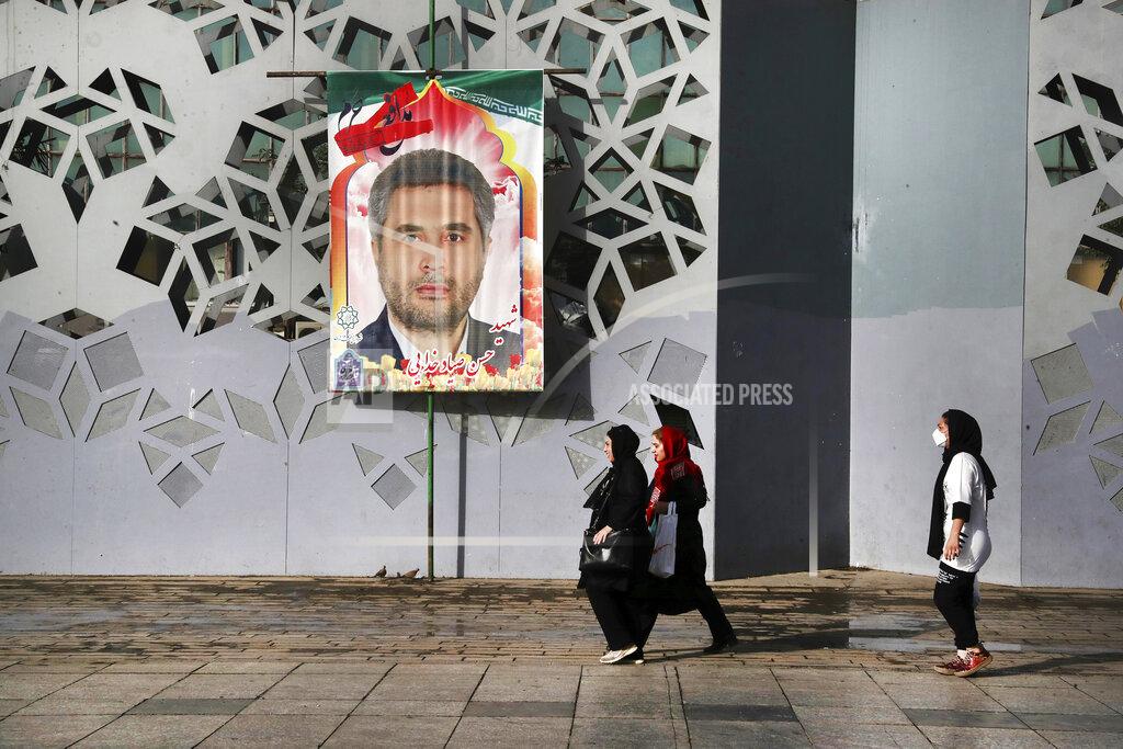 Vahid Salemi People walk past a banner showing Iran's Revolutionary Guard Col. Hassan Sayyad Khodaei who was killed on Sunday, prior to his funeral ceremony, in Tehran, Iran, Tuesday, May 24, 2022. Iran's hard-line President Ebrahim Raisi vowed revenge on Monday over the killing of Khodaei, who was shot at his car by two assailants outside his home in Tehran, a still-mysterious attack on the country's powerful paramilitary force. (AP Photo/Vahid Salemi)