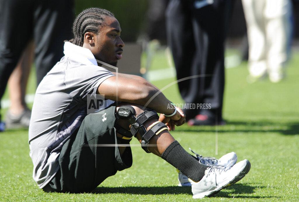 Mary Ann Chastain FILE - In this March 27, 2013, file photo, running back Marcus Lattimore looks out on the field before the start of the South Carolina's NFL Pro Day in Columbia, S.C. Lattimore’s task these days comes away from the field in helping the Gamecocks handle the stresses of major college football and prepare for life when the games are over. Few know better than Lattimore, 27, how things can change for a can’t-miss NFL prospect. (AP Photo/Mary Ann Chastain, File)