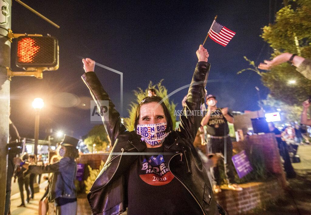 Jenni Girtman Angie Whitworth Pace of Tucker, Ga., reacts to election results favoring President-elect Joe Biden and Vice President-elect Kamala Harris in East Atlanta on Saturday, Nov 7, 2020. (Jenni Girtman/Atlanta Journal-Constitution via AP)
