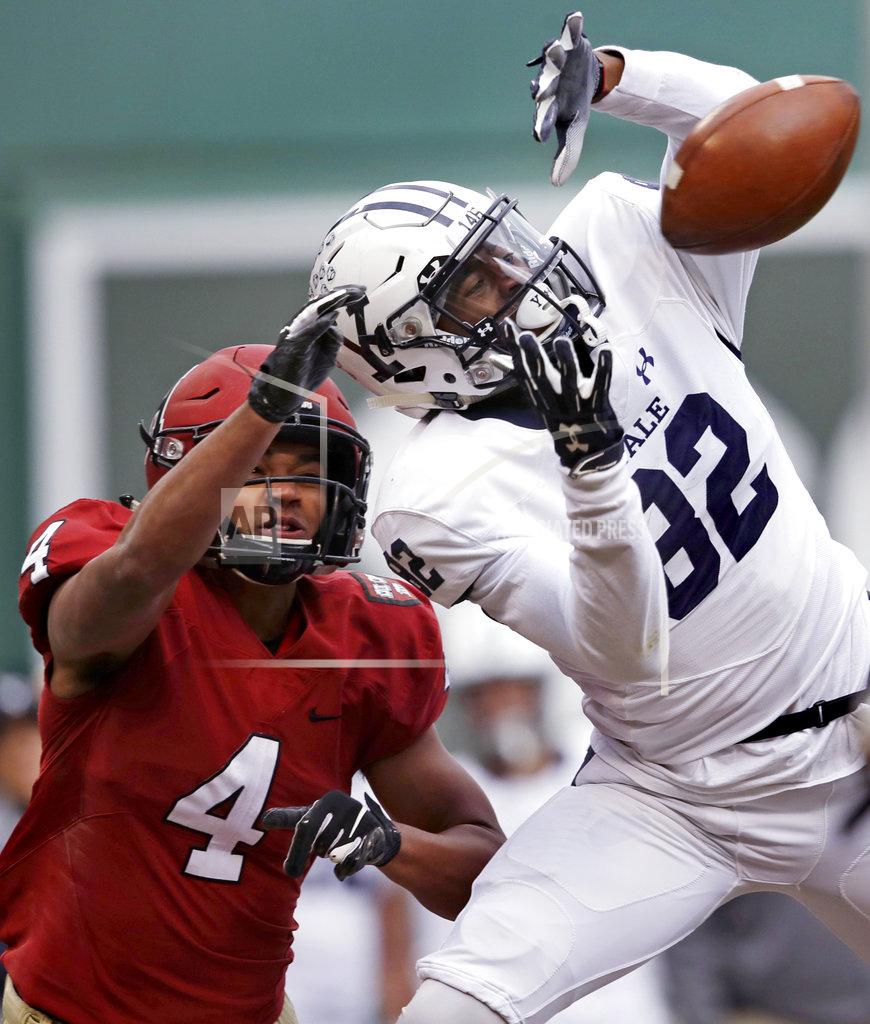 Charles Krupa Yale wide receiver Jaylan Sandifer (82) reaches up for a pass against Harvard defensive back Max Jones (4) during the first half an NCAA college football game at Fenway Park in Boston, Saturday, Nov. 17, 2018. Jones was charged with pass interference on the play. (AP Photo/Charles Krupa)