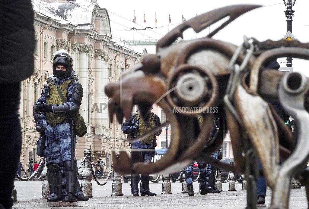 Dmitri Lovetsky Russian Rosguardia (National Guard) soldiers stand at a central avenue next to a street sculpture, a day before Sunday's protest in St. Petersburg, Russia, Saturday, Jan. 30, 2021. As part of a multipronged effort by the authorities to discourage Russians from attending Sunday's demonstrations, the Prosecutor General's office ordered the state communications watchdog, Roskomnadzor, to block the calls for joining the protests on the internet. The Prosecutor General's office and the Interior Ministry also issued stern warnings to the public not to join the protests, saying participants could face criminal charges of taking part in mass riots if the rallies turn violent. (AP Photo/Dmitri Lovetsky)