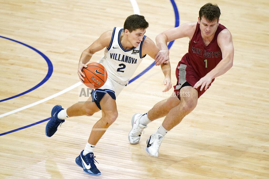 Matt Slocum Villanova's Collin Gillespie (2) dribbles against Saint Joseph's Ryan Daly (1) during the second half of an NCAA college basketball game, Saturday, Dec. 19, 2020, in Villanova, Pa. (AP Photo/Matt Slocum)