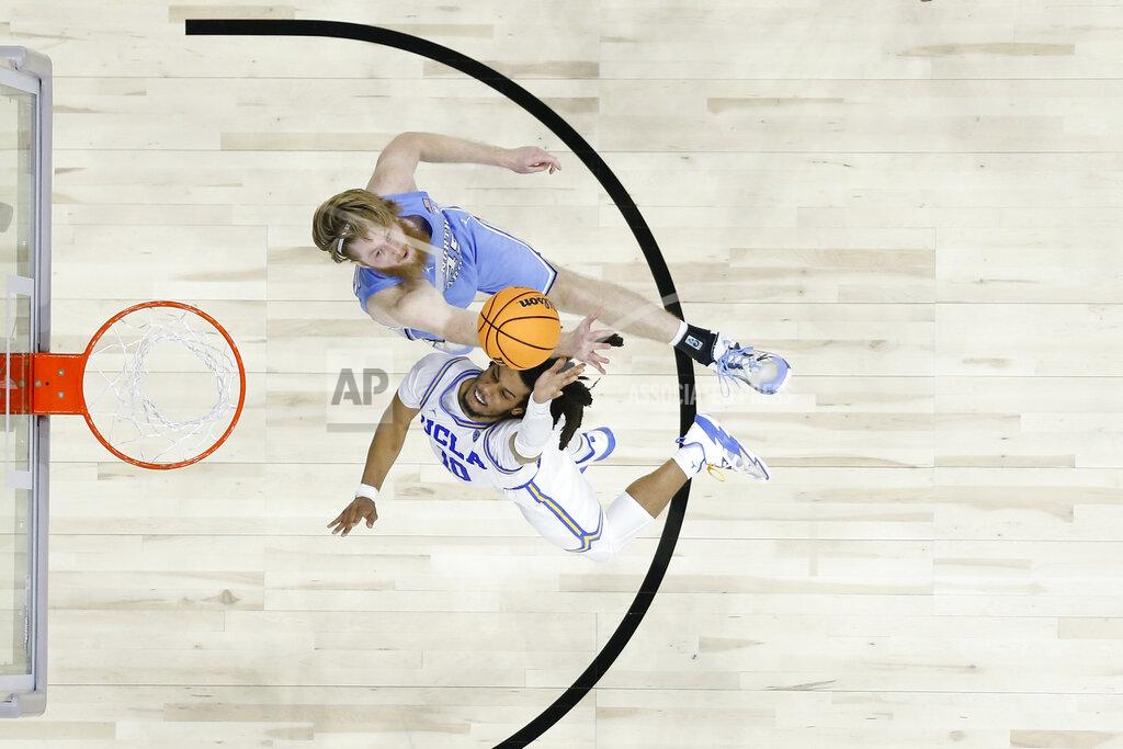 Chris Szagola UCLA's Tyger Campbell, bottom, cannot get a shot past North Carolina's Brady Manek during the second half of a college basketball game in the Sweet 16 round of the NCAA tournament, Friday, March 25, 2022, in Philadelphia. (AP Photo/Chris Szagola)