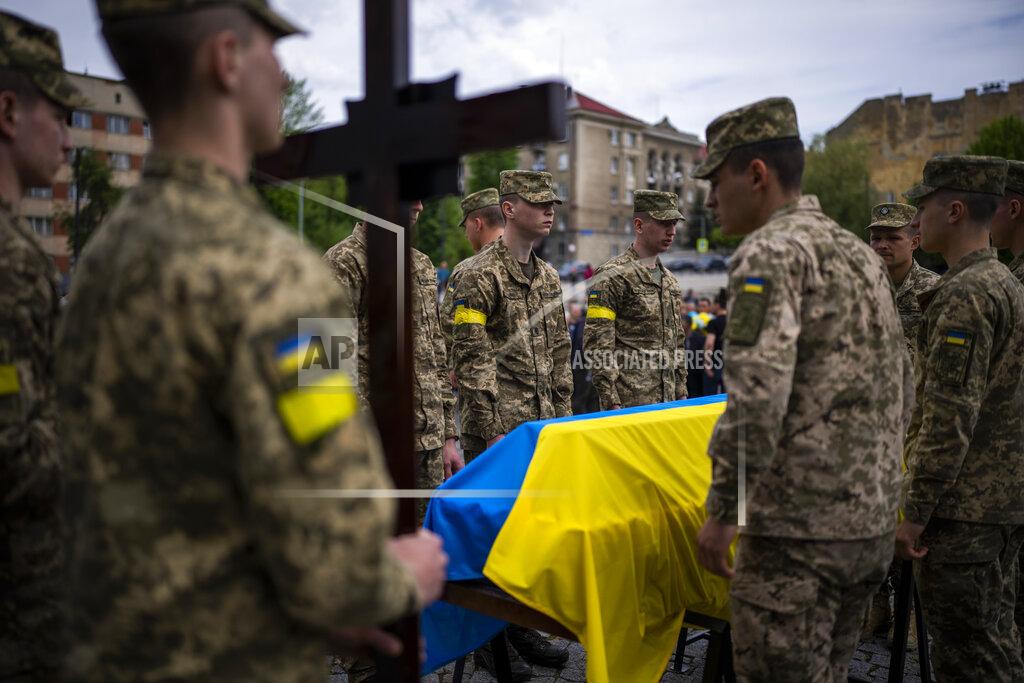 Emilio Morenatti Ukrainian soldiers attend the funeral of Melnyk Andriy, Shufryn Andriy and Ankratov Oleksandra, three Ukrainian military servicemen who were killed in the east of the country, in Lviv, Ukraine, Saturday, May 14, 2022. (AP Photo/Emilio Morenatti)