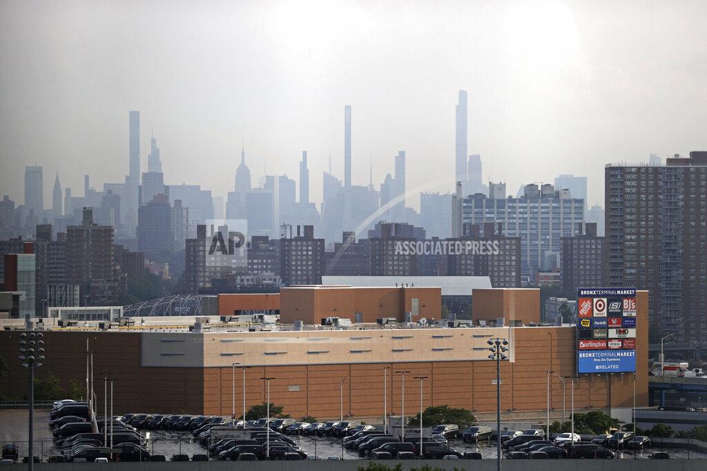 Adam Hunger Manhattan is seen from Yankee Stadium through a haze of smoke before a baseball game between the Philadelphia Phillies and the New York Yankees, Wednesday, July 21, 2021, in New York. Wildfires in the American West, including one burning in Oregon that's currently the largest in the U.S., are creating hazy skies as far away as New York as the massive infernos spew smoke and ash into the air in columns up to six miles high. (AP Photo/Adam Hunger)