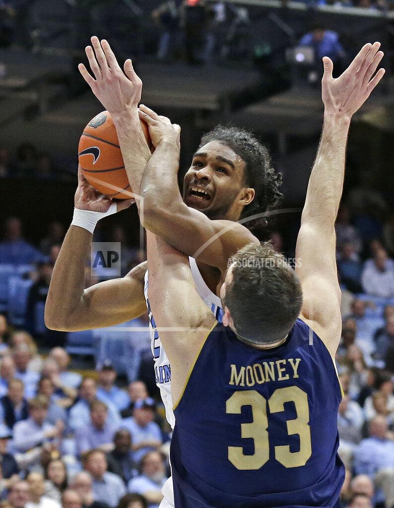 Gerry Broome North Carolina's Coby White looks for a shot while Notre Dame's John Mooney (33) defends during the first half of an NCAA college basketball game in Chapel Hill, N.C., Tuesday, Jan. 15, 2019. (AP Photo/Gerry Broome)