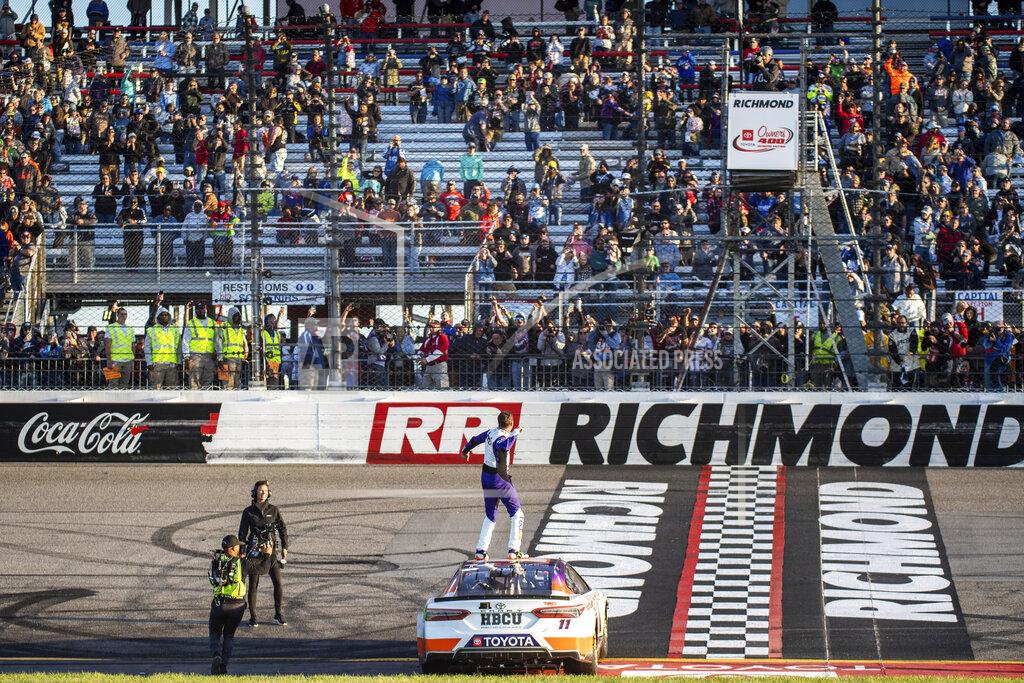 Mike Caudill Denny Hamlin stands on his car after winning the NASCAR Cup Series auto race at Richmond Raceway on Sunday, April 3, 2022, in Richmond, Va. (AP Photo/Mike Caudill)