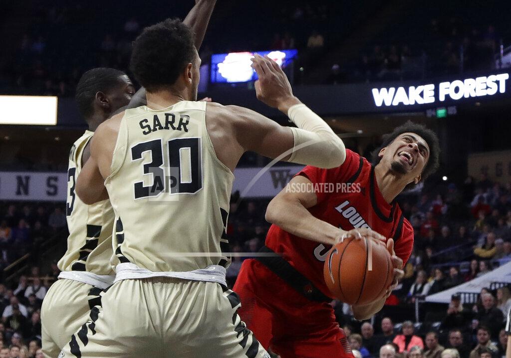 Chuck Burton Louisville's Malik Williams (5) looks to shoot against Wake Forest's Olivier Sarr (30) during the first half of an NCAA college basketball game in Winston-Salem, N.C., Wednesday, Jan. 30, 2019. (AP Photo/Chuck Burton)