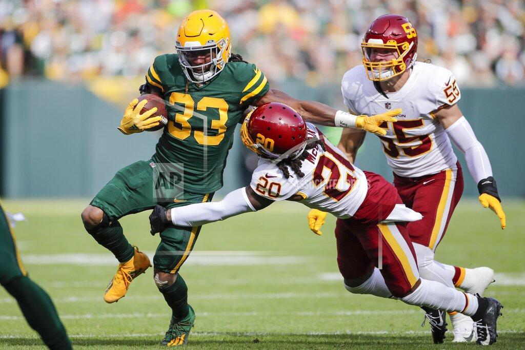 Aaron Gash Green Bay Packers' Aaron Jones tries to get past Washington Football Team's Bobby McCain during the first half of an NFL football game Sunday, Oct. 24, 2021, in Green Bay, Wis. (AP Photo/Aaron Gash)