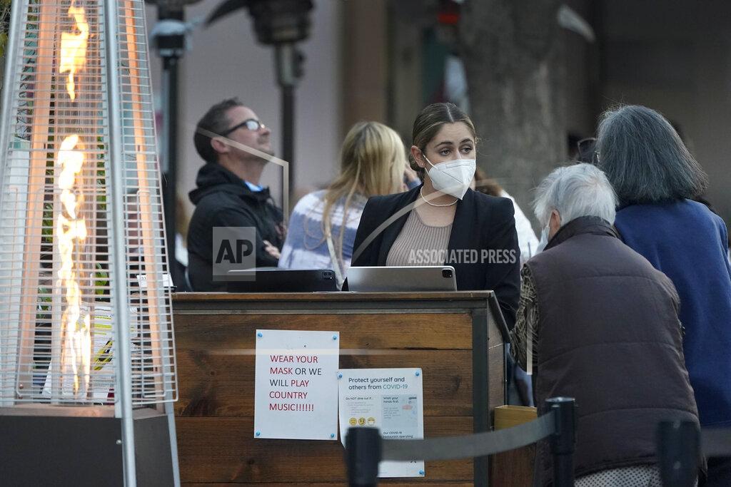 Marcio Jose Sanchez A hostess seats customers in an outdoor dining area amid the COVID-19 pandemic on The Promenade Wednesday, June 9, 2021, in Santa Monica, Calif. (AP Photo/Marcio Jose Sanchez)