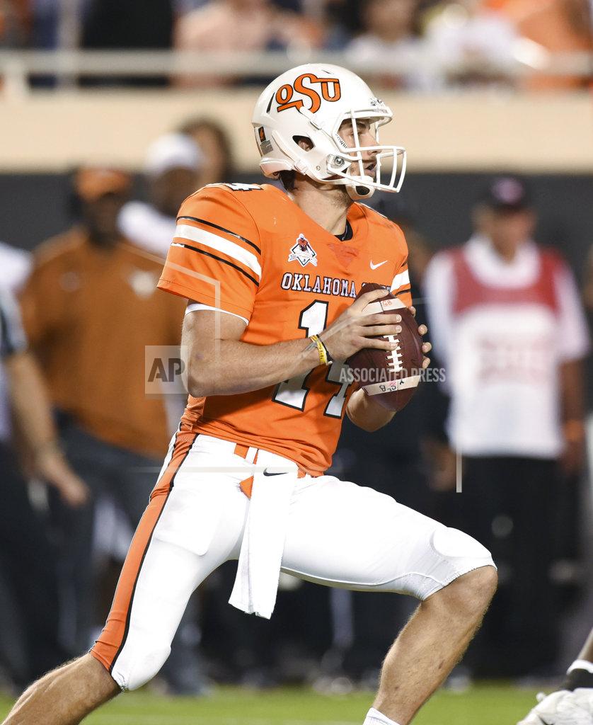 Brody Schmidt Oklahoma State quarterback Taylor Cornelius looks for an open teammate in the second half of an NCAA college football game in Stillwater, Okla., Saturday, Oct. 27, 2018. Cornelius threw for 321 yards in the Oklahoma State 38-35 win over Texas. (AP Photo/Brody Schmidt)