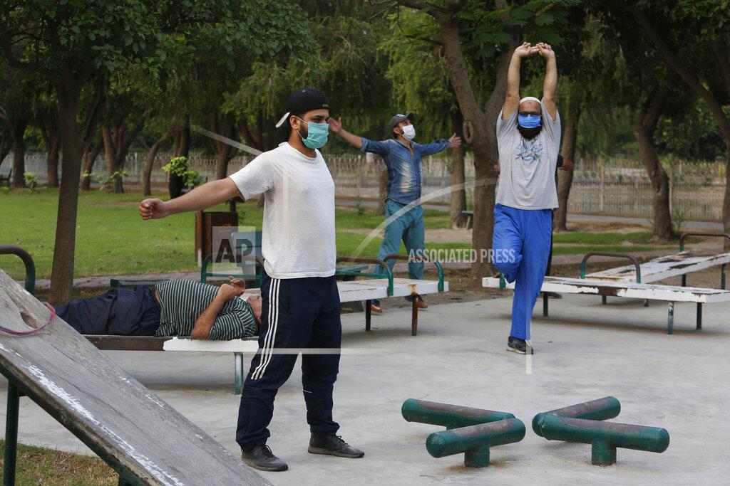 K.m. Chaudary People exercise in a park in Lahore, Pakistan, Friday, June 5, 2020. Government of Pakistan's Punjab province has reopened parks in different cities of the province including Lahore amid coronavirus outbreak. (AP Photo/K.M. Chaudary)