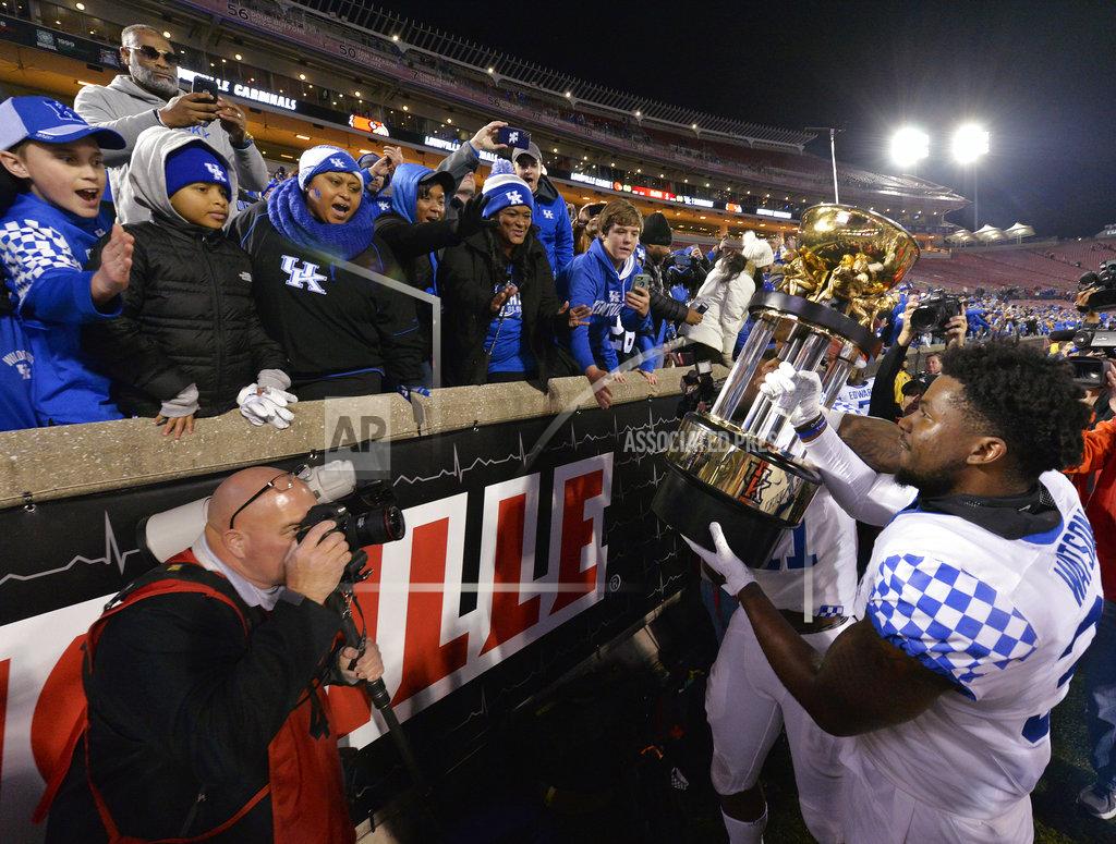 Timothy D. Easley Kentucky linebacker Jamar Watson holds up the Governor's Cup to the fans following Kentucky's 56-10 victory over Louisville in an NCAA college football game, in Louisville, Ky., Saturday, Nov. 24, 2018. (AP Photo/Timothy D. Easley)
