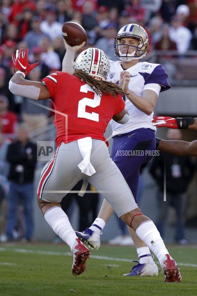 Jae C. Hong Washington quarterback Jake Browning throws a pass under pressure from Ohio State defensive end Chase Young during the first half of the Rose Bowl NCAA college football game Tuesday, Jan. 1, 2019, in Pasadena, Calif.(AP Photo/Jae C. Hong)