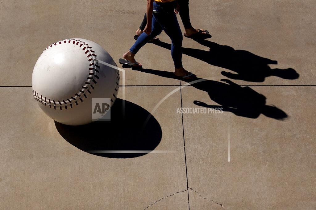 Charlie Riedel People enter Peoria Sports Complex before a spring training baseball game between the San Diego Padres and the Chicago Cubs, Monday, March 1, 2021, in Peoria, Ariz. (AP Photo/Charlie Riedel)