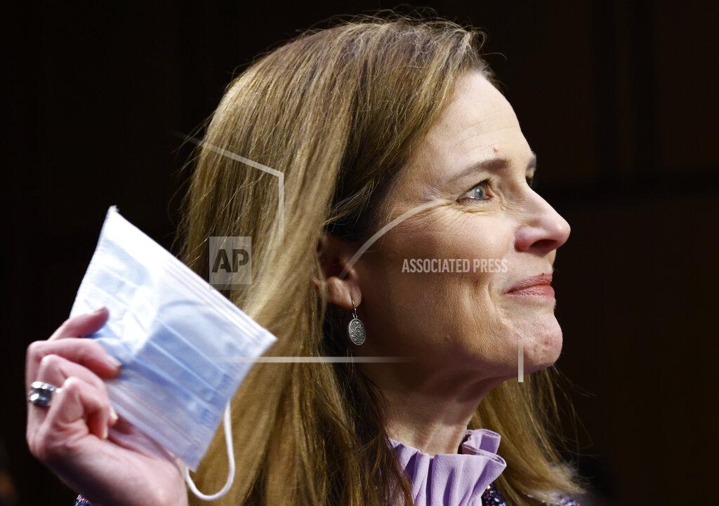 Samuel Corum Supreme Court nominee Amy Coney Barrett holds a face mask up as she testifies during the third day of her confirmation hearings before the Senate Judiciary Committee on Capitol Hill in Washington, Wednesday, Oct. 14, 2020. (Photo by Samuel Corum/Getty Images)