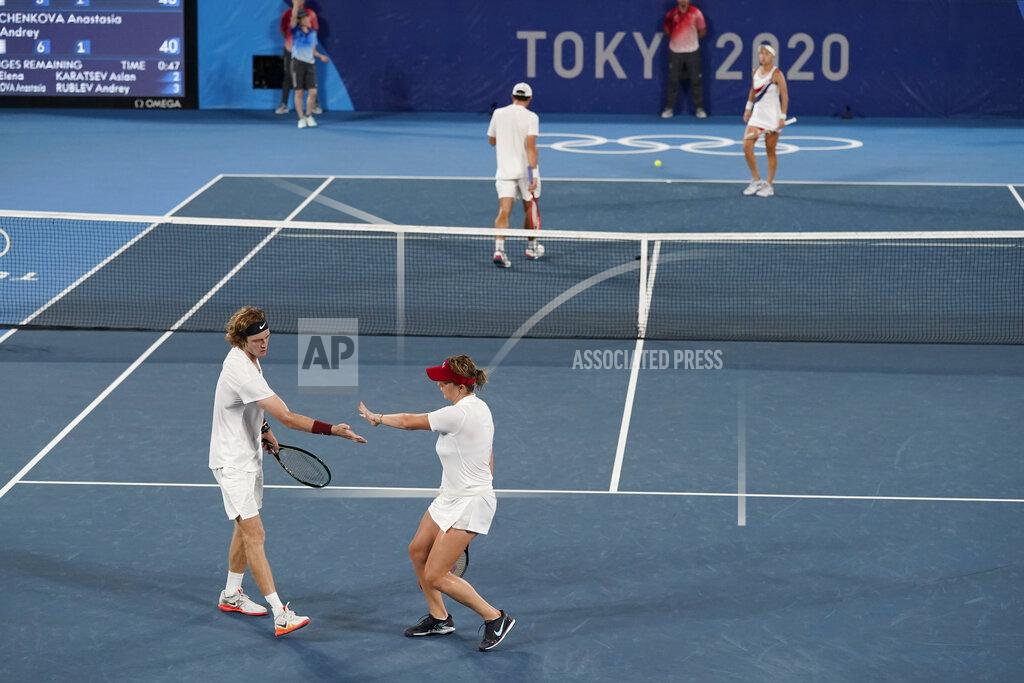 Anastasia Pavlyuchenkova and Andrey Rublev, of the Russian Olympic Committee, celebrate a point during the mixed doubles gold medal match of the tennis competition at the 2020 Summer Olympics, Sunday, Aug. 1, 2021, in Tokyo, Japan. (AP Photo/Patrick Semansky)