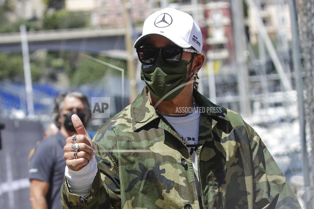 Luca Bruno Mercedes driver Lewis Hamilton of Britain gives the thumb-up sign as he walks in the paddock at the Monaco racetrack, in Monaco, Wednesday, May 19, 2021. The Formula one race will be held on Sunday. (AP Photo/Luca Bruno)