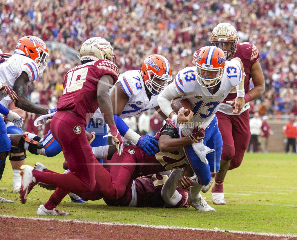 Mark Wallheiser Florida quarterback Feleipe Franks (13) is brought down short of the goal line by Florida State defensive back Jaiden Woodbey (20) in the first half of an NCAA college football game in Tallahassee, Fla., Saturday, Nov. 24, 2018. (AP Photo/Mark Wallheiser)