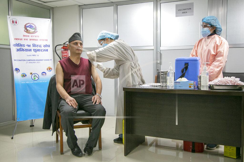 Niranjan Shrestha A Nepalese doctor receives AstraZeneca/Oxford University vaccine, at Teaching Hospital in Kathmandu, Nepal, Wednesday, Jan. 27, 2021. Thousands of health workers lined up across Nepal to get the coronavirus vaccine Wednesday as the Himalayan nation began its campaign to get the population vaccinated within three months. Neighboring India gifted Nepal 1 million doses of the vaccine manufactured under license by the Serum Institute of India. (AP Photo/Niranjan Shrestha)