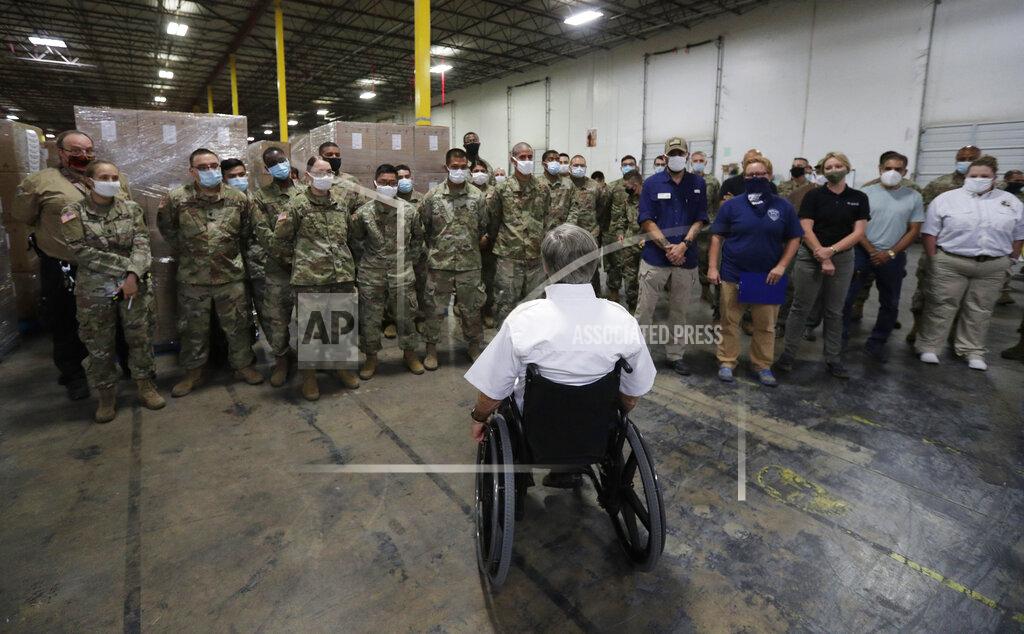 Eric Gay Texas Gov. Greg Abbott, foreground, addresses members of the National Guard during a visit to a Texas Division of Emergency Management Warehouse filled with Personal Protective Equipment during the coronavirus pandemic, Tuesday, Aug. 4, 2020, in San Antonio. (AP Photo/Eric Gay)