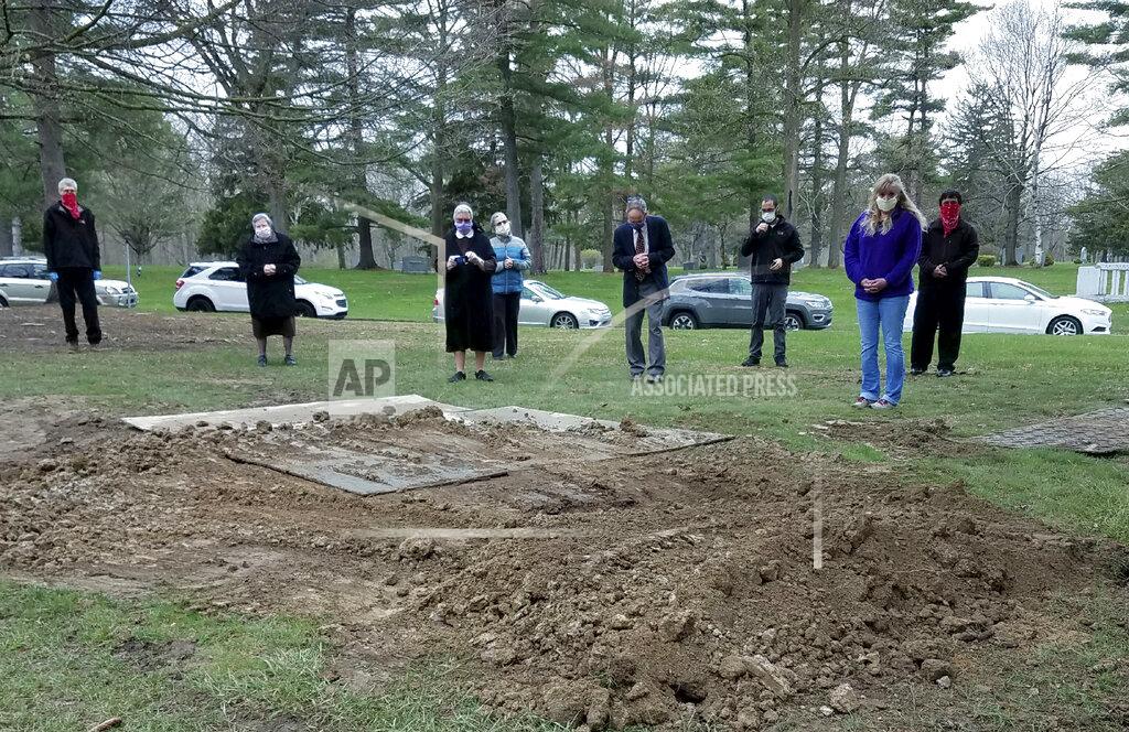 Sister Mary Alfonsa Van Overberghe In this April 24, 2020, photo provided by Sister Mary Alfonsa Van Overberghe, nuns from a convent in Livonia, and others gather at the burial site of one of 13 nuns who have died from the coronavirus in the Michigan city. (Sister Mary Alfonsa Van Overberghe via AP)