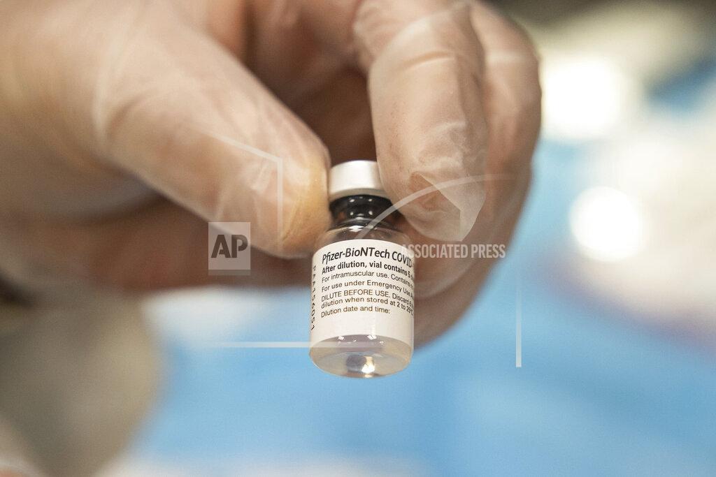 Yuki Iwamura CVS Pharmacist Gerard Diebner shows the COVID-19 vaccine at Harlem Center for Nursing and Rehabilitation, a nursing home facility, on Friday, Jan. 15, 2021 in Harlem neighborhood of New York. (AP Photo/Yuki Iwamura)